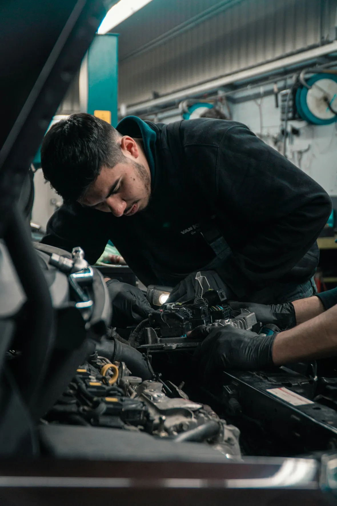 Sfeerbeeld van een monteur die aan een automotor werkt